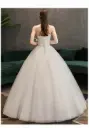 Luxurious wedding dress with long sleeves and an elegant train for a fairytale princess look