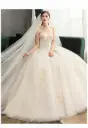 Luxurious wedding dress with long sleeves and an elegant train for a fairytale princess look