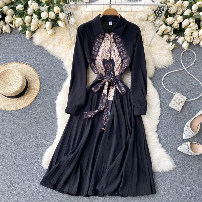A long dress adorned with classic prints, featuring meticulous stitching and a loose, flowing silhouette