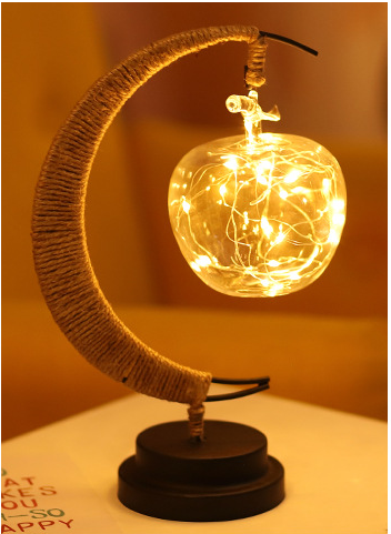 A Ramadan LED lamp with a modern design made from luxurious copper wire in the shape of a moon and stars