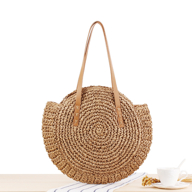 A simple round straw bag with a one-shoulder design, crafted using unique weaving techniques
