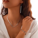 A trendy necklace featuring a flat snake chain design, adding a sleek and modern touch with a simple geometric style