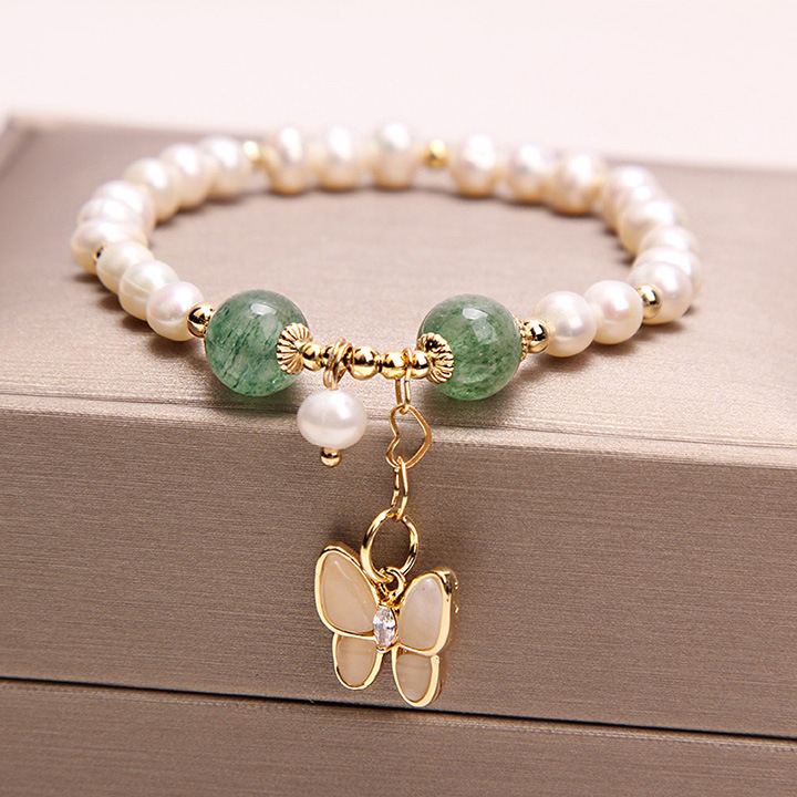 Elegant bracelet featuring freshwater pearls and strawberry quartz, accented with an opal butterfly pendant