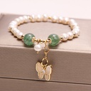 Elegant bracelet featuring freshwater pearls and strawberry quartz, accented with an opal butterfly pendant