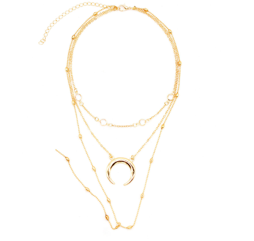 An elegant multilayer necklace featuring a crescent moon pendant and a bead chain, perfect for adding a touch to your look