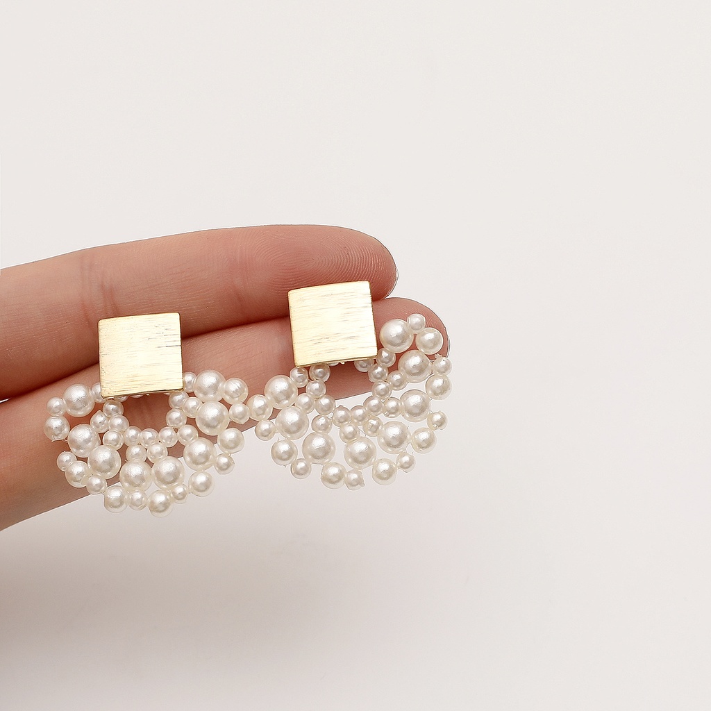 Elegant earrings with a woven pearl scalloped design, carefully handmade to add a touch of sophistication to your look