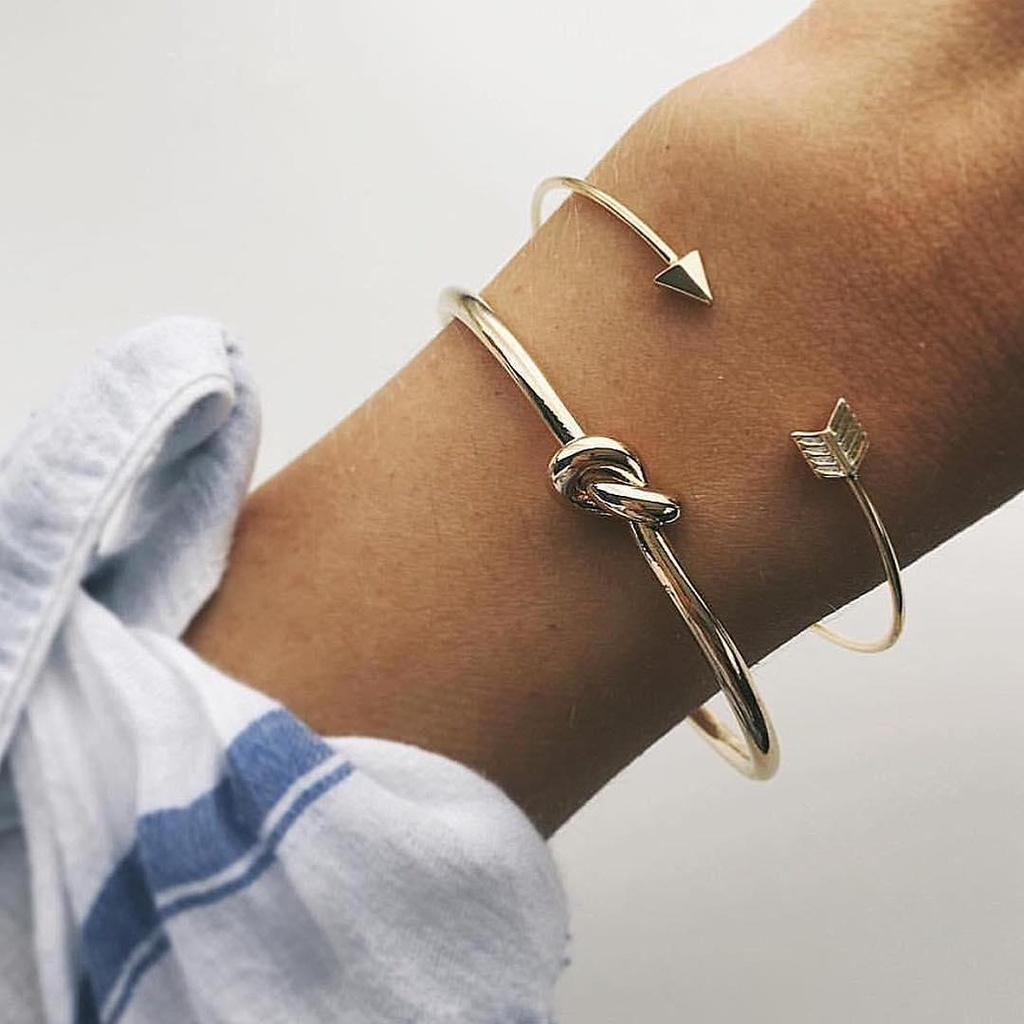An elegant cuff bracelet with an arrow knot design, perfect for adding a bold and modern touch to your look