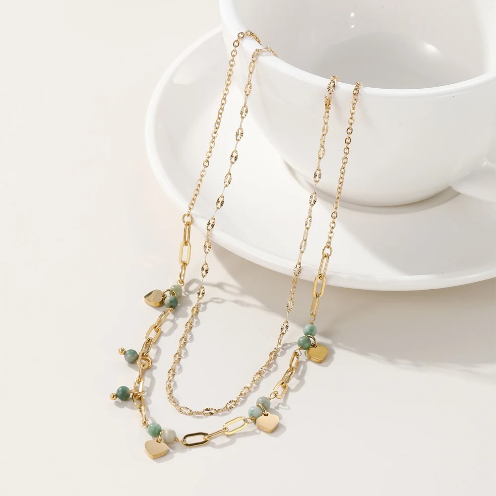 An elegant necklace featuring a combination of green malachite stones, perfect for adding a bold and modern touch to your look