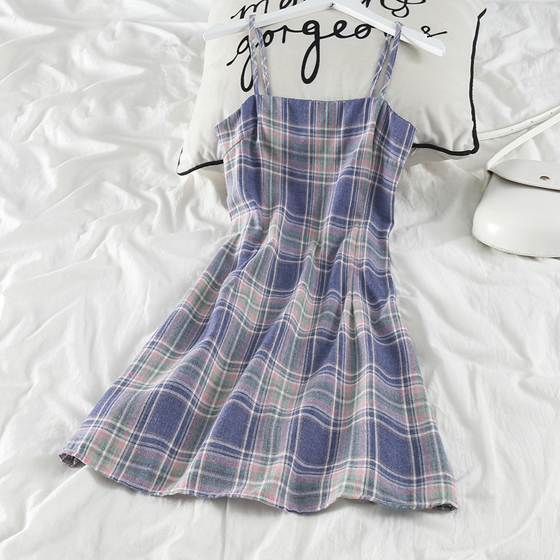 Elegant dress with classic plaid pattern and suspenders, offering a feminine everyday look with a modern touch