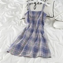 Elegant dress with classic plaid pattern and suspenders, offering a feminine everyday look with a modern touch