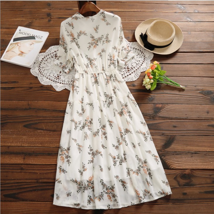 Women's mid-length chiffon dress adorned with elegant floral patterns, offering a soft and feminine look—perfect for both special occasions and everyday wear