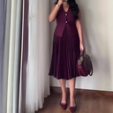 Elegant women's set featuring a sleeveless jacket with a V-neck and a stylish pleated skirt