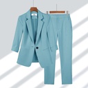 Practical and modern women's set consisting of a casual blazer with front buttons and straight zipper pants in a solid color