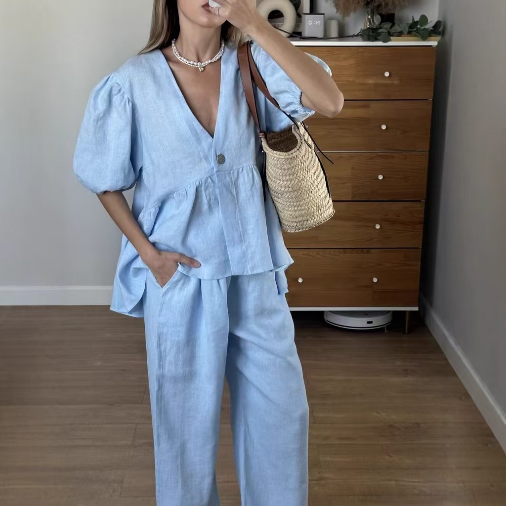 Elegant solid-color set featuring a V-neck puff-sleeve top with a waist tie, paired with matching trousers for a feminine and modern look