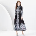 Long printed dress with elegant wavy edges, combining classic style with refined feminine charm