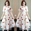 Mid-length polka dot dress featuring a waist tie that defines the figure and adds an elegant, streamlined look