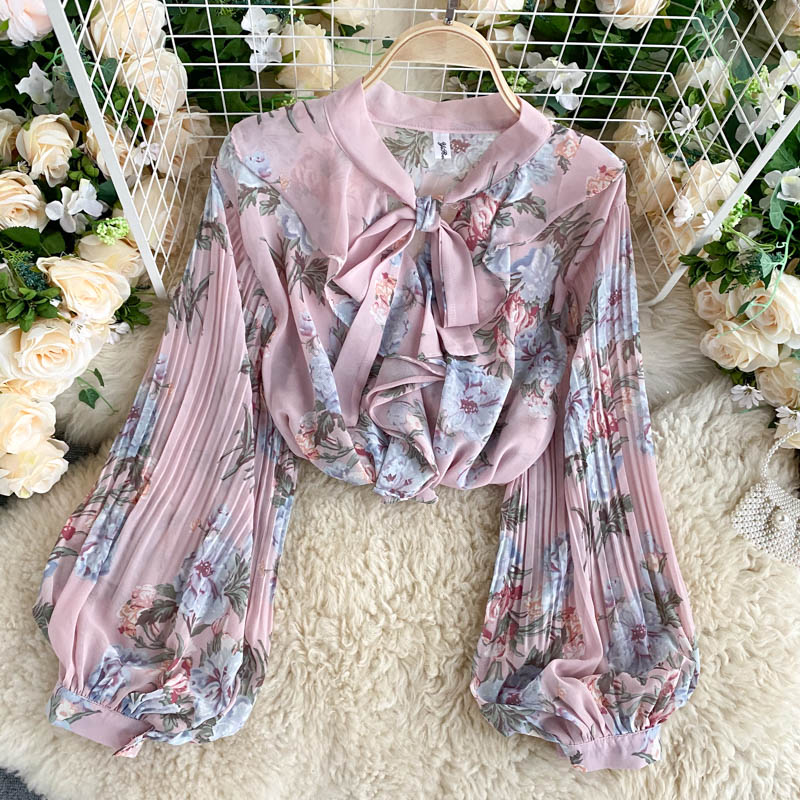 Elegant women's shirt with a classic French touch, featuring a V-neck with a front bow and long lantern sleeves adorned with a soft floral print for a charming feminine look