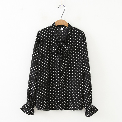Stylish shirt adorned with modern polka dot patterns, featuring a tie-neck design that adds a charming feminine touch