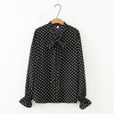 Stylish shirt adorned with modern polka dot patterns, featuring a tie-neck design that adds a charming feminine touch