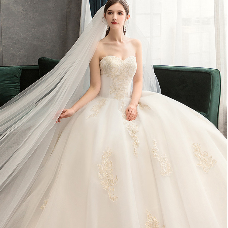 Luxurious wedding dress with long sleeves and an elegant train for a fairytale princess look