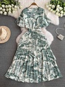 A fitted dress with a printed pleated waist that adds an alluring touch