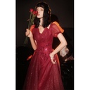 An elegant evening gown featuring puff sleeves, a backless design, and shimmering accents that lend it a special allure