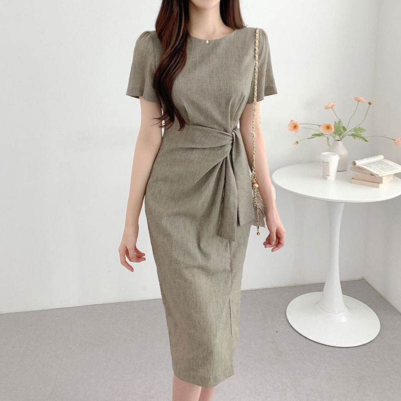 A women’s dress with a round neckline and a wrap-tie waist