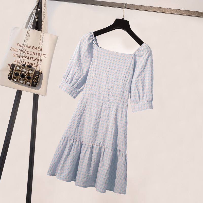 A stately dress featuring a plaid pattern inspired by French elegance