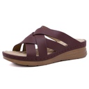 A sandal-Slipper with cross straps and a sloped heel, featuring air-cooled soles and a massage footbed