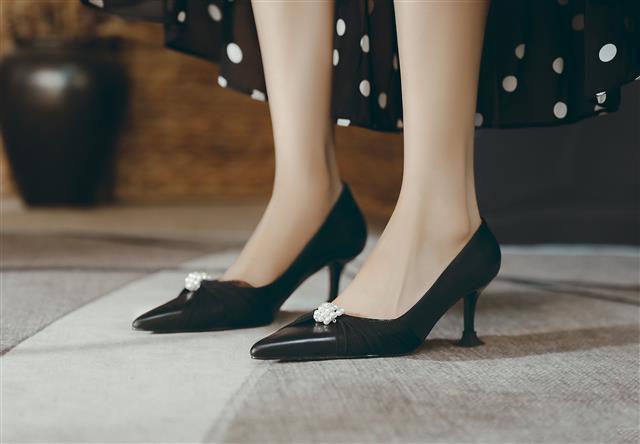 Leather stiletto heels adorned with pearls, featuring a pointed toe and single strap