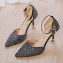 A high-heeled, pointed-toe shoe with a low-cut vamp and sparkling sequins