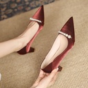 A high‑heeled pointed‑toe shoe adorned with pearls for a feminine casual look