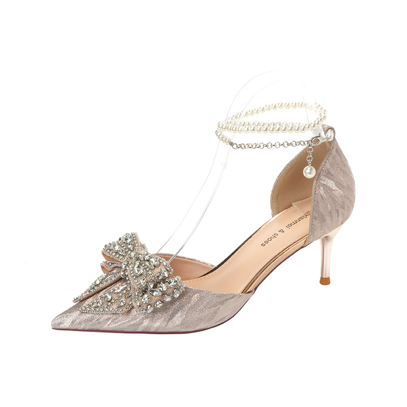 Elegant pointy shoes adorned with a rhinestone bow and pearls