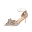 Elegant pointy shoes adorned with a rhinestone bow and pearls