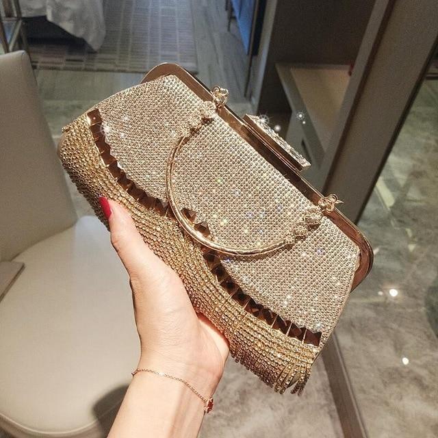 Luxury women's evening clutch bag adorned with rhinestones in a gold design