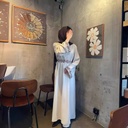 An elegant and modern lined linen dress adorned with embroidery and a belt