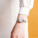 A quartz watch with a mesh band, featuring a simple modern design adorned with an elegant Roman pattern, and distinguished by its water resistance