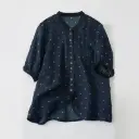 Elegant women's shirt made of natural ramie fabric, adorned with polka dot print and a feminine classic touch