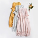 Elegant solid-color dress featuring a round neckline and delicate embroidery