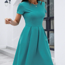 Elegant pleated dress with slant side pockets and a solid color design