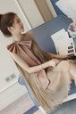 A midi dress with an elegant vest-style design, featuring a large front bow at the waist