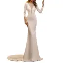 A slim-fitting, solid-color evening dress featuring a round neckline and long sleeves for an elegant, captivating look