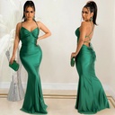 A fitted, solid-color dress featuring strap detailing for an alluring feminine look