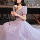 An elegant evening gown featuring puff sleeves, a backless design, and shimmering accents that lend it a special allure