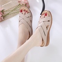 A sandal-Slipper with cross straps and a sloped heel, featuring air-cooled soles and a massage footbed