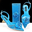 A set featuring a high‑heeled shoe and a satin bag adorned with flowers and rhinestones