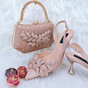 A women’s set featuring handmade shoes and a bag, adorned with leaf motifs and elegant details