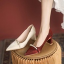 A high‑heeled pointed‑toe shoe adorned with pearls for a feminine casual look