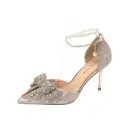 Elegant pointy shoes adorned with a rhinestone bow and pearls