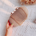 Elegant frosted clutch bag worn as a crossbody
